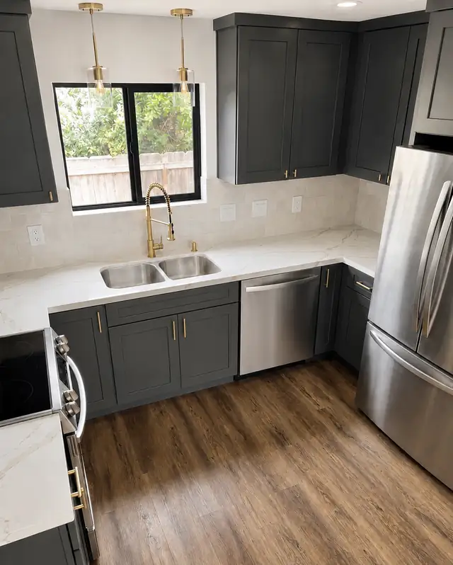 Kitchen with charcoal shaker cabinets, brass pendant lights, a gold faucet, white quartz counters and wood-look plank floor